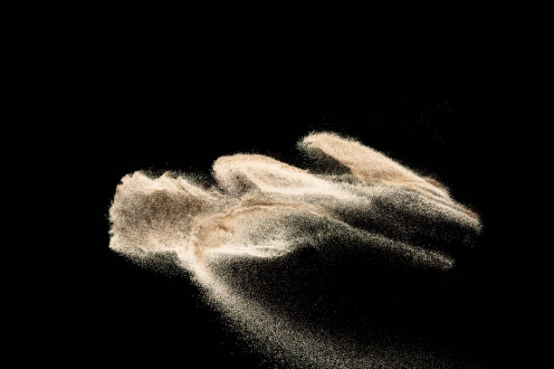 istock Brown colored sand splash.Dry river sand explosion isolated on black background. Abstract sand cloud. 1215323495