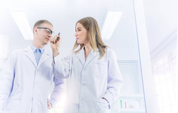 istock Scientists brainstorming for some confidential and write a plan on transparent board in laboratory 1215327728
