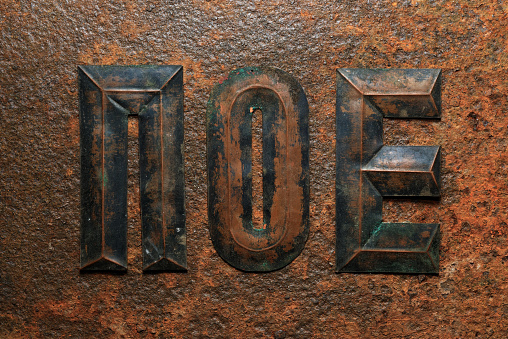 Backgrounds and textures: group of aged embossed copper cyrillic letters on heavily corroded rusty metal surface