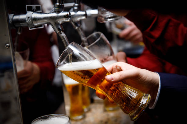 istock Barman pours beer into a glass. 1215328583