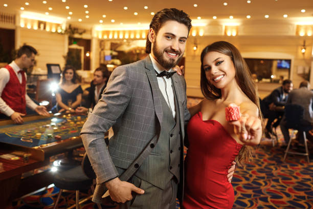 istock Happy couple holding roulette chips in their hands. 1215329574