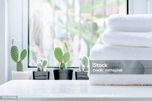 Clean Towel On White Table Near Window Sill Stock Photo - Download Image Now - Towel, Bathroom, Bar Counter