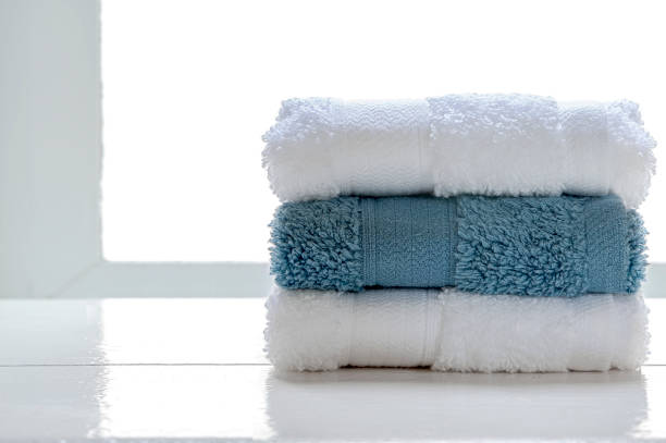 istock Stacked clean spa towels on wooden table. 1215329792