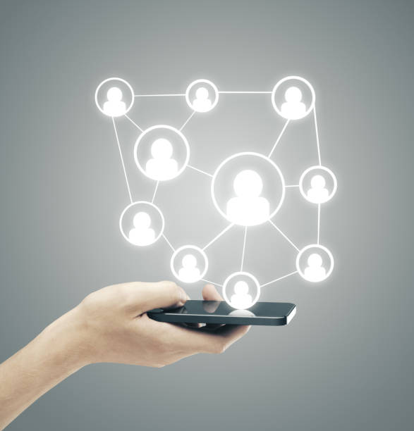 istock Hand hodling smartphone with social media plan. 1215331015