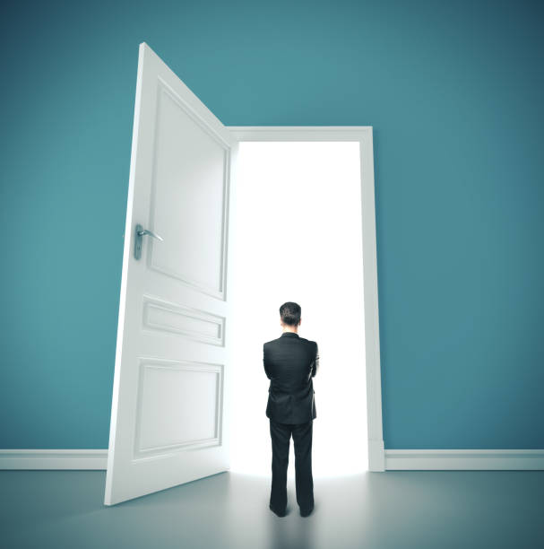 istock Businessman standing in blue room. 1215331628