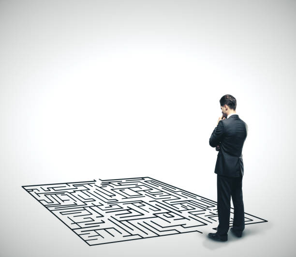 istock Businessman looking at labyrinth. 1215332218