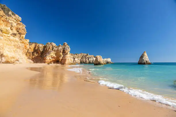 Photo of View on typical cliffy beach at Algarve coastline in Portugal in summer