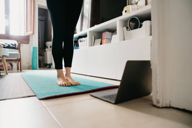 istock Young woman practicing yoga at home 1215333217
