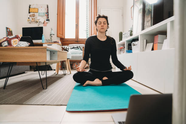 istock Young woman practicing yoga at home 1215333227