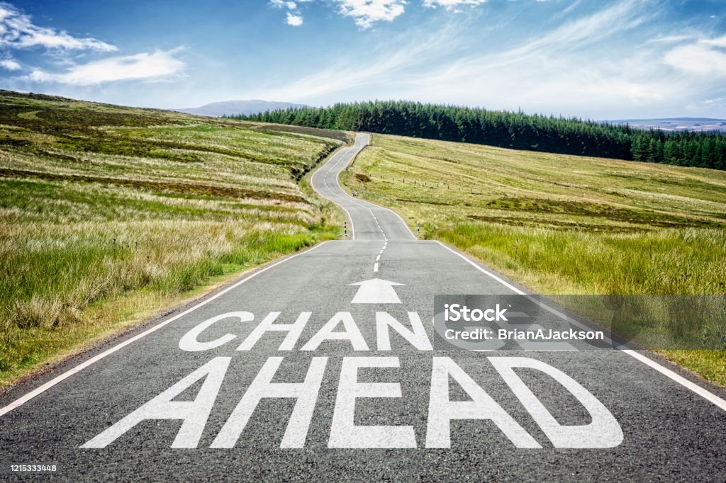 Change ahead sign on the road disappearing into the distance Change ahead sign on the highway disappearing into the distance concept for business planning, strategy and challenge or career path, opportunity and changes Change Stock Photo