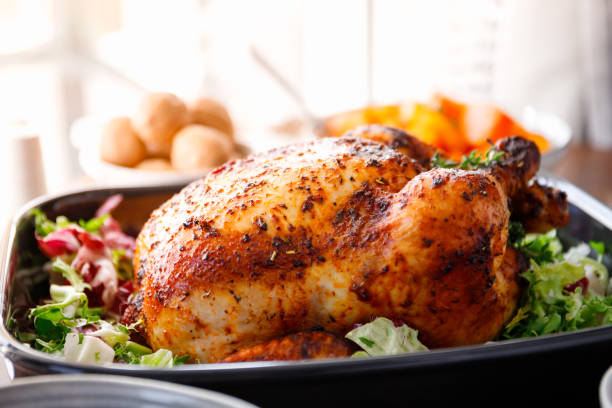 istock Whole roasted chicken with fresh salad in black dish 1215333615