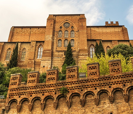 Ancient catholic cathedral and wall of  ancient fortress in Siena