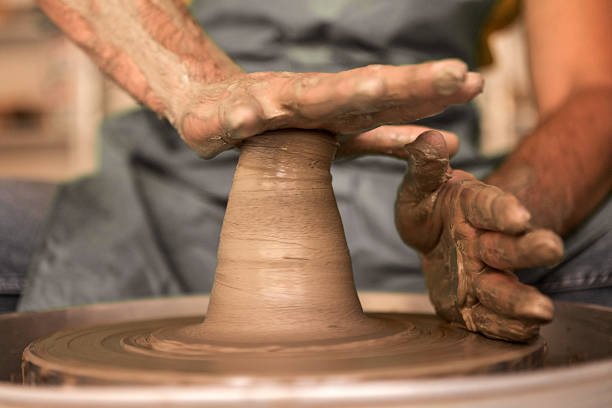 istock Crafty Pottery makers hand molding clay 1215335215