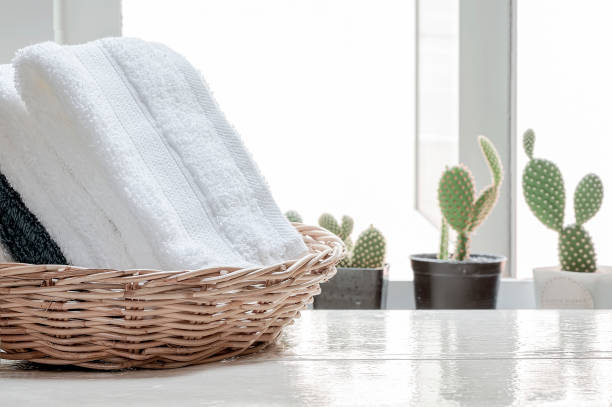 istock Folded spa towels in a basket  on white wooden table. 1215335216