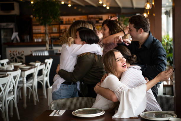 istock Young colleagues watching something on the phone at the restaurant 1215336144