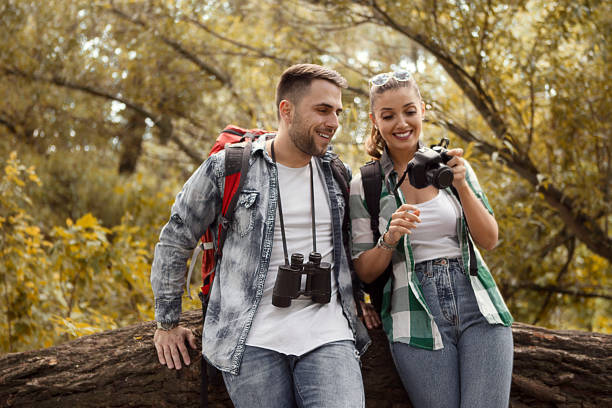 istock Young couple taking a break from hiking looking at photos 1215338299