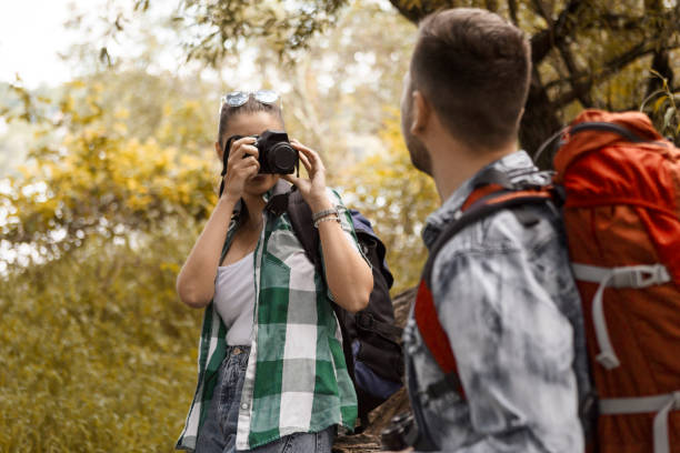 istock Hikers with backpacks taking photos 1215338392