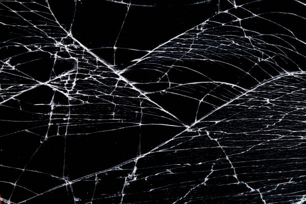 istock cracked glass isolated on a black background. 1215339458