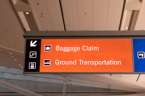Las Vegas, Nevada, USA - March 2020: View of an airport sign indicating baggage claim and ground transportation at McCarran International Airport.