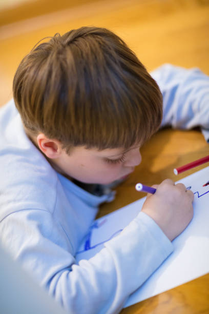 istock Little boy drawing at home 1215340813