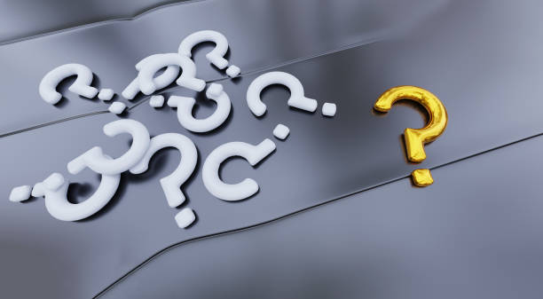 istock Several White Question Mark and One Big Gold Question Mark put on a Grey Metallic surface with soft reflections 1215340896