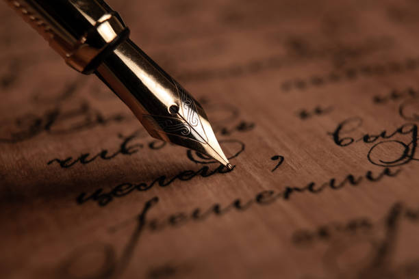 istock fountain pen on paper with ink text on the wooden desk closeup 1215347320