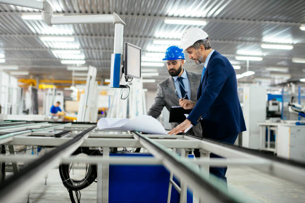 istock Engineers talking while inspecting machinery stock photo 1215347904