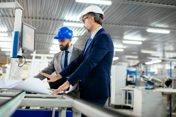 istock Engineers talking while inspecting machinery stock photo 1215347935
