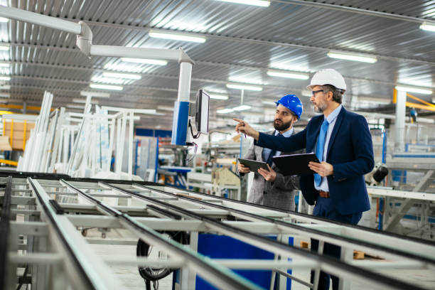 istock Engineers talking while inspecting machinery stock photo 1215348025