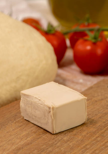 Fresh brewer's yeast for the preparation of pizza, bread and pastries. Cube of brewer's yeast, used in cooking to grow pizza and cake dough. bakers yeast stock pictures, royalty-free photos & images