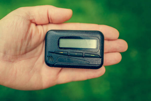 istock pager, old vintage beeper. pager in hand 1215349994