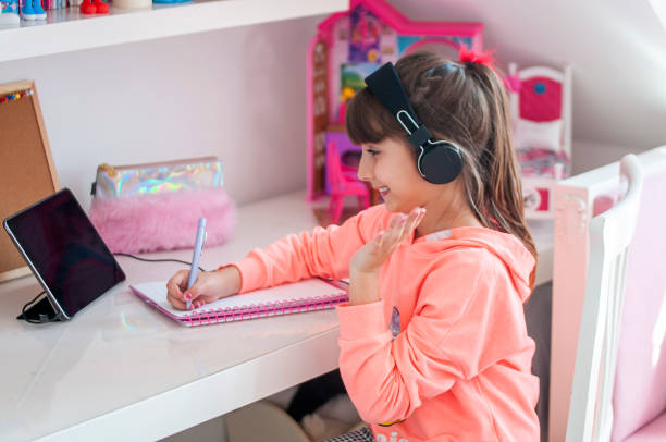 istock Cute girl online education at home 1215351237