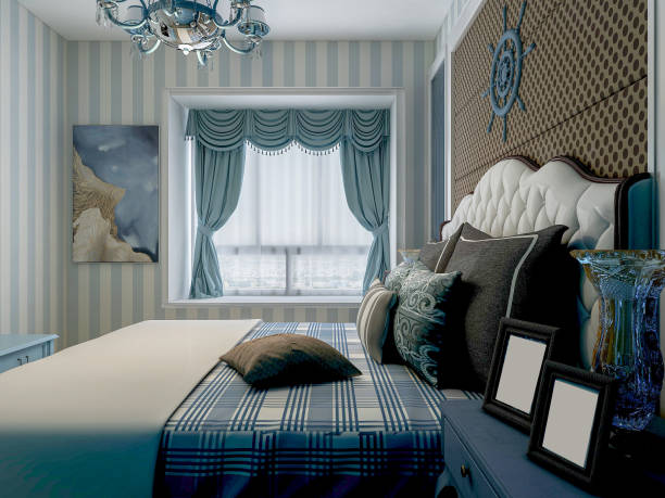 Modern, cobalt blue bedroom with double bed, gray bedding, carpet and window