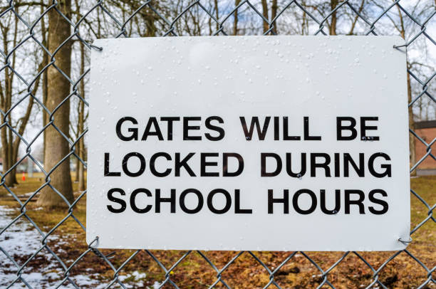 istock Gate Security Sign on School Fence with playground in background 1215353817