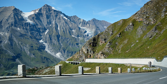 Driving north along Grossglockner High Alpine Road.  In the distance, several motorcyclists enjoy riding the windy road