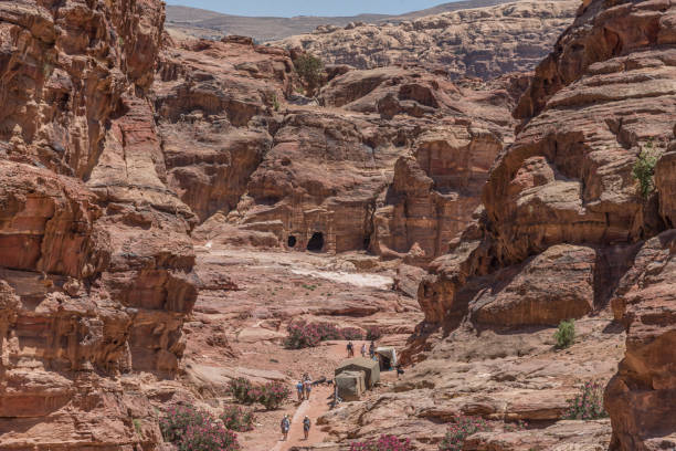 istock Climbing to impressive Ad Deir Monastery, 800 rock-cut steps. General view on Jordan Rift Valley and Royal Tombs 1215356848
