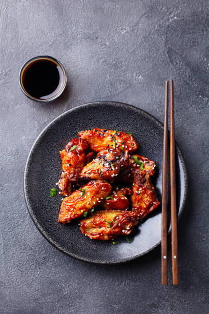 istock Chicken wings. Traditional Asian recipe. Dark background. Copy space. Top view. 1215358251