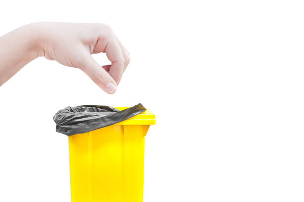 hand women Pick catch , yellow Garbage bins isolated on white background