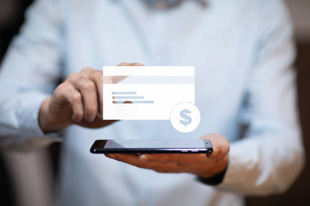 istock man hand phone with credit card icon in screen 1215364274