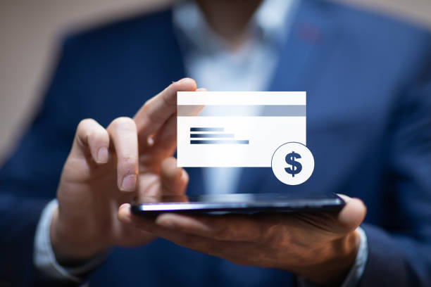 istock man hand phone with credit card icon in screen 1215364300