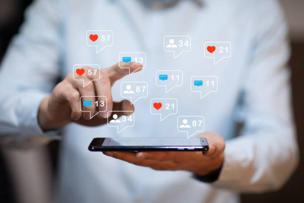 istock man hand using smartphone with colorful application icons around 1215364343