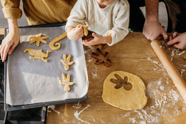 istock Young family spending time together in the kitchen while making cookies 1215364414