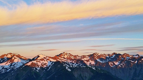 The sun rises over the Olympic Mountains in Washington State, from Marmot Pass.