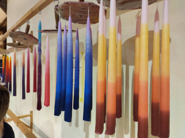 Handmade candles hanged on wax rope after manufacturing stock photo