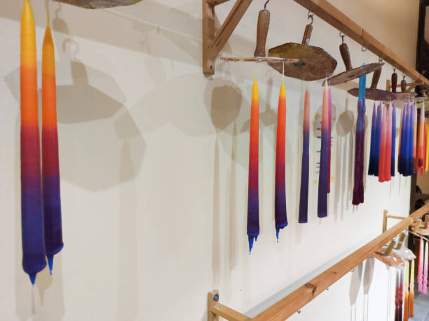 istock Handmade candles hanged on wax rope after manufacturing 1215367476