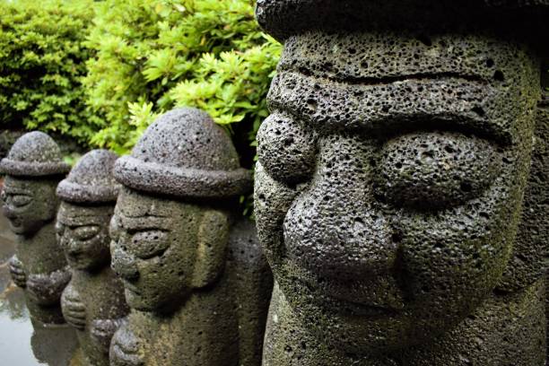 istock Dol hareubang rock statues in Jeju, Korea 1215367909