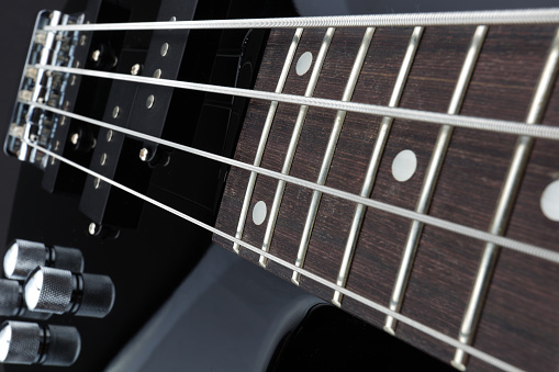 A Bass guitar neck pickups bridge volume pots selective focus