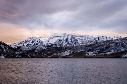 This is a view of Mount Timpanogos in northern Utah as viewed from the edge of Deer Creek Reservoir.  This shot was taken during a dramatic winter sunset with the golden sky reflecting on the dark water of the lake.