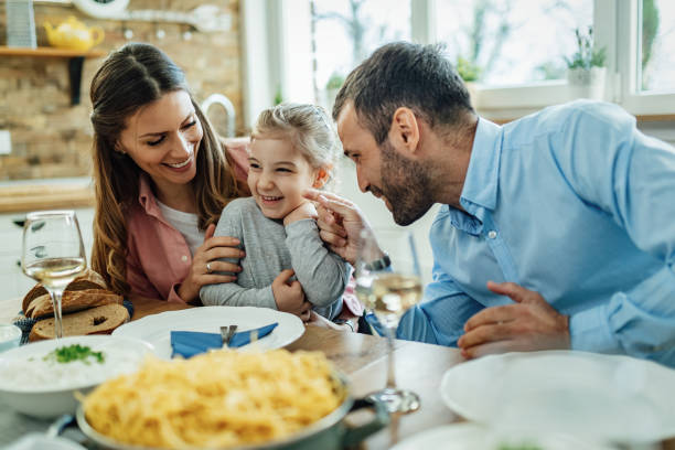 istock Cheerful family having fun during lunch at dining table. 1215369444