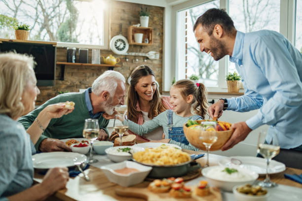 glückliche großfamilie mit spaß beim familienessen im speisesaal. - essen mund benutzen fotos stock-fotos und bilder